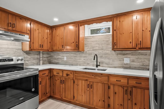 3 Laurie, Harwich, MA 02646 - kitchen featuring stainless steel appliances, a sink, under cabinet range hood, brown cabinets, and recessed lighting