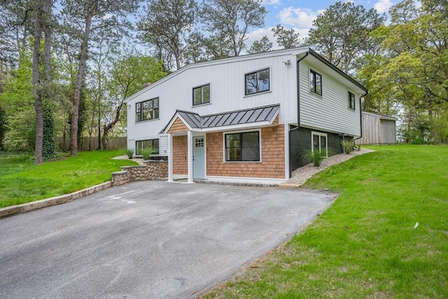3 Laurie, Harwich, MA 02646 - view of front of property featuring a standing seam roof, a front yard, and metal roof