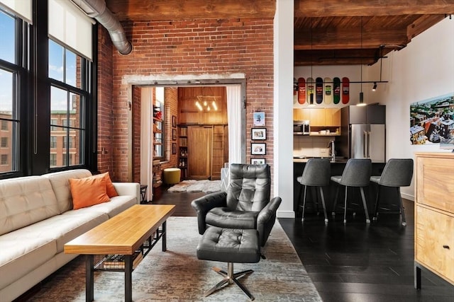 interior space with a towering ceiling, dark wood-style floors, and beamed ceiling