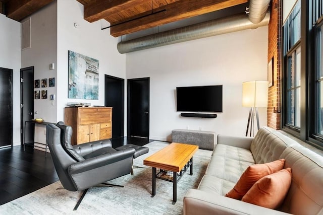 living room featuring a high ceiling, beamed ceiling, wood finished floors, and wood ceiling