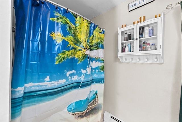 bathroom featuring baseboard heating and curtained shower