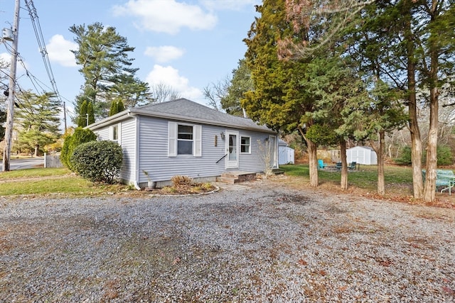 bungalow-style home featuring a storage shed