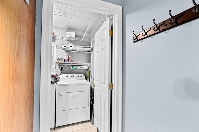 laundry room with light tile patterned flooring and washing machine and dryer