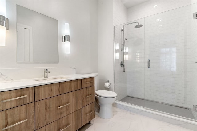 bathroom with vanity, a shower with door, and toilet