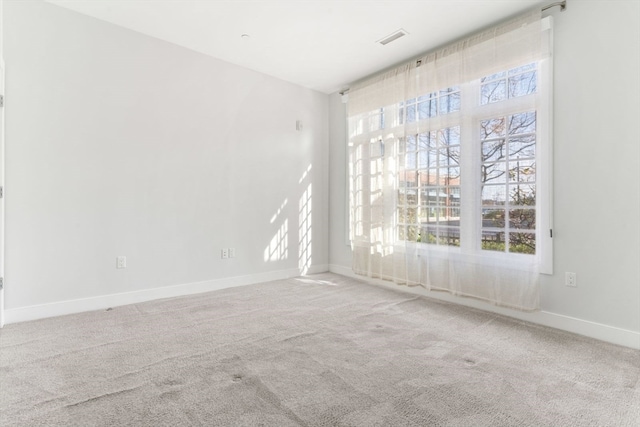 spare room with carpet and plenty of natural light