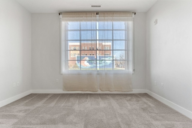 carpeted empty room featuring plenty of natural light