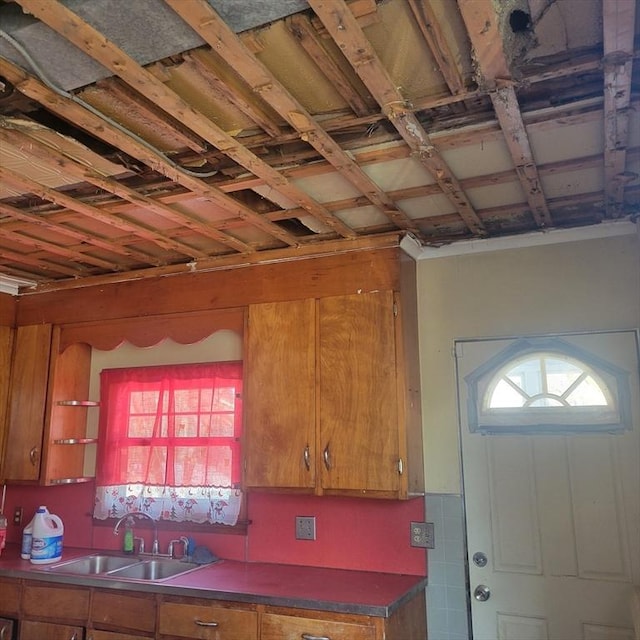 kitchen featuring brown cabinetry and a sink