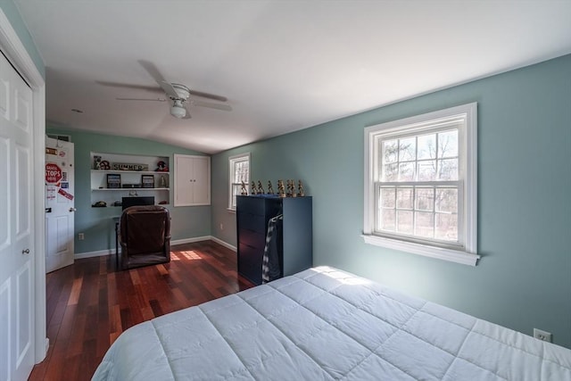 bedroom featuring wood finished floors, ceiling fan, multiple windows, and vaulted ceiling