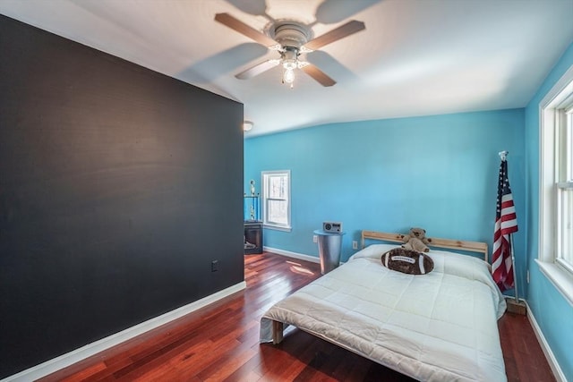 bedroom with wood finished floors, ceiling fan, and baseboards