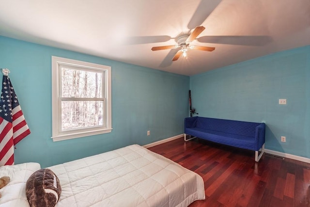 bedroom featuring baseboards, ceiling fan, and wood finished floors