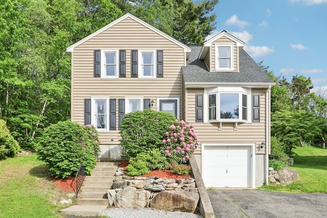 23 Jasmine Ct, Dracut, MA 01826 - view of front of home with a garage, a shingled roof, asphalt driveway, and a front yard