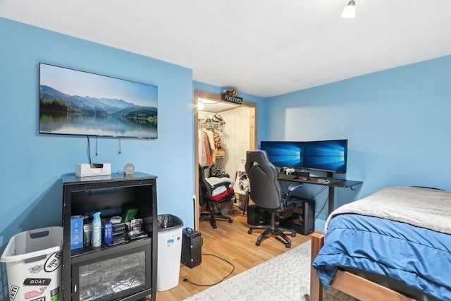 23 Jasmine Ct, Dracut, MA 01826 - bedroom featuring a walk in closet, wood finished floors, a desk, and a closet