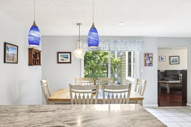 23 Jasmine Ct, Dracut, MA 01826 - tiled dining room featuring a textured ceiling