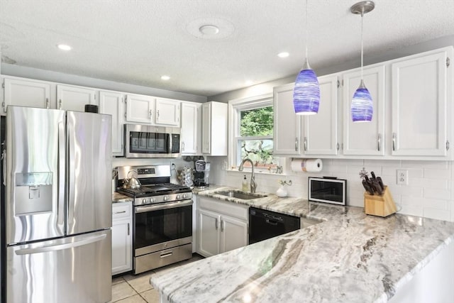 23 Jasmine Ct, Dracut, MA 01826 - kitchen with appliances with stainless steel finishes, a sink, light stone countertops, white cabinets, and hanging light fixtures