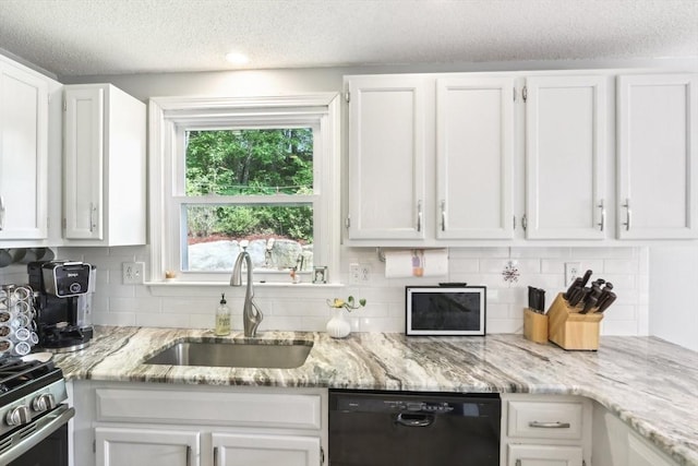 23 Jasmine Ct, Dracut, MA 01826 - kitchen featuring black dishwasher, a sink, white cabinets, and a textured ceiling