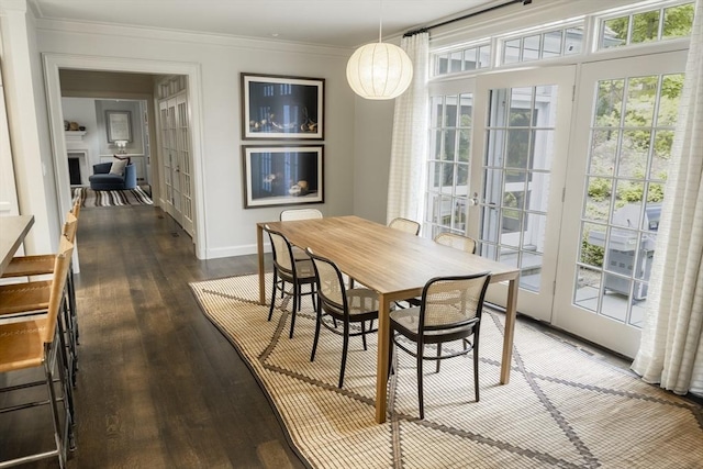 dining space with ornamental molding, dark hardwood / wood-style floors, and french doors