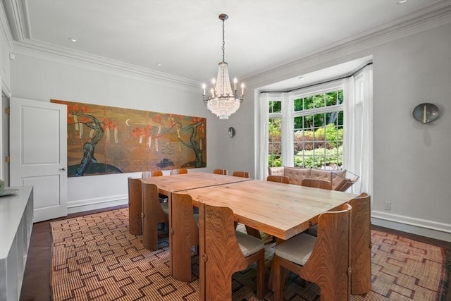 dining room with hardwood / wood-style floors, ornamental molding, and a chandelier