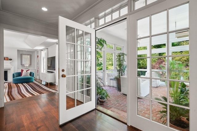 doorway to outside featuring dark hardwood / wood-style flooring, crown molding, and french doors