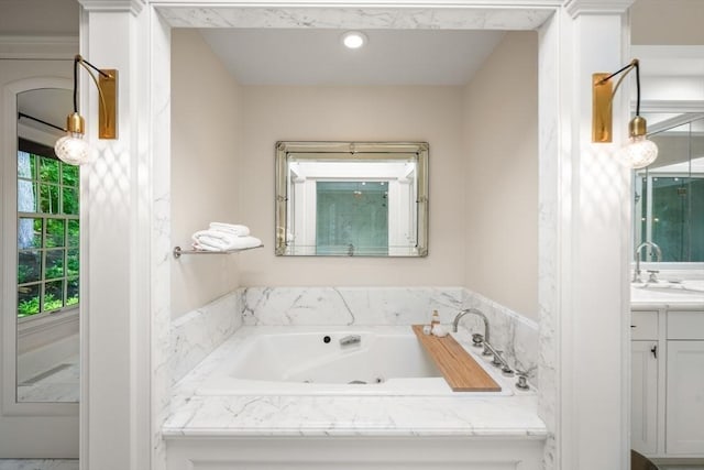 bathroom with vanity and a bath