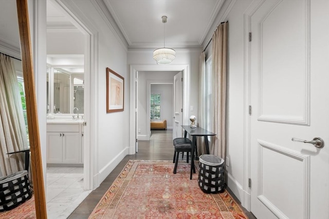 hallway featuring sink and crown molding