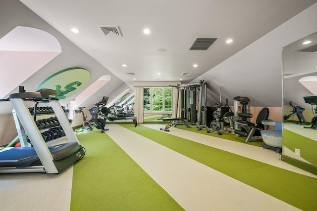 exercise area featuring vaulted ceiling and carpet flooring