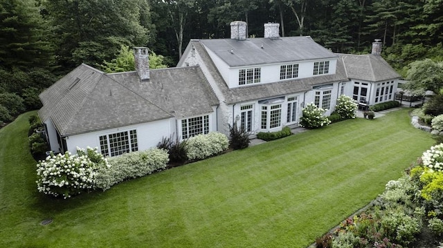 rear view of property featuring a yard and french doors