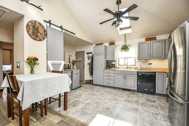 kitchen with gray cabinets, dishwasher, and stainless steel refrigerator