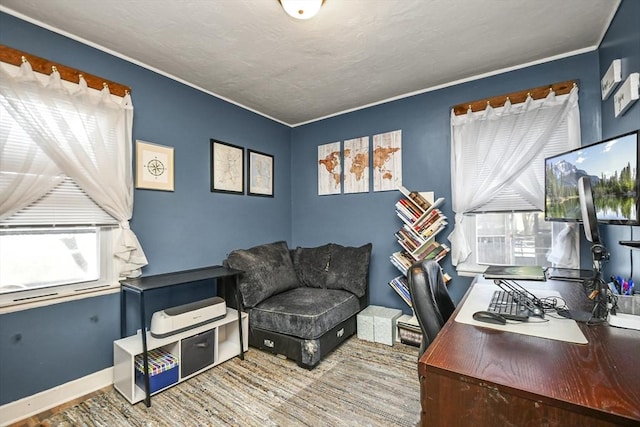 home office with a wealth of natural light, crown molding, and hardwood / wood-style floors