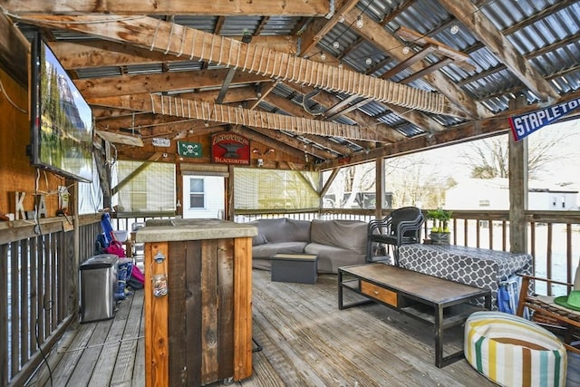 wooden terrace featuring an outdoor bar and an outdoor hangout area