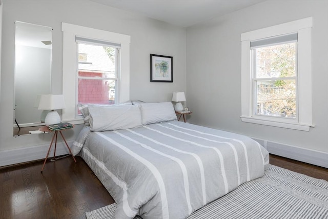 bedroom featuring baseboards and wood finished floors