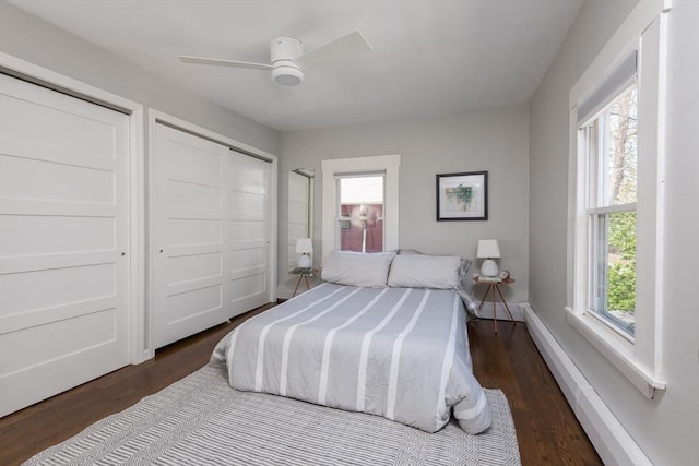 bedroom with a ceiling fan, multiple windows, and wood finished floors