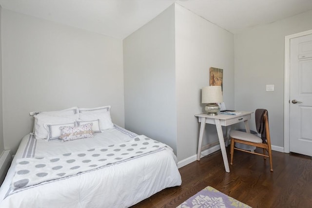 bedroom featuring baseboards and wood finished floors