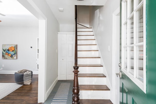 stairway with baseboards and wood finished floors