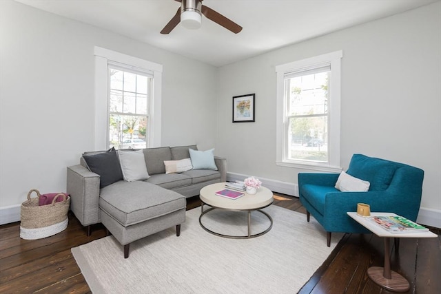 living room featuring baseboards, ceiling fan, plenty of natural light, and wood finished floors
