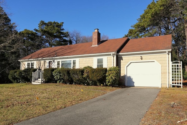 view of front facade with a garage and a front lawn