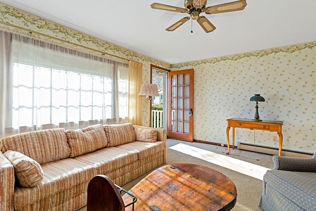 carpeted living room featuring ceiling fan and baseboard heating