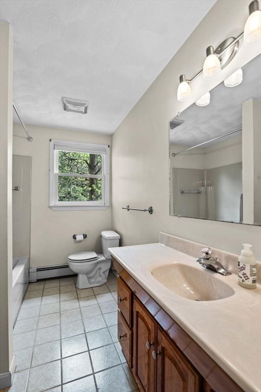 5 Emery Ct, Stoneham, MA 02180 - full bathroom with baseboard heating, vanity, toilet, bathing tub / shower combination, and tile patterned floors