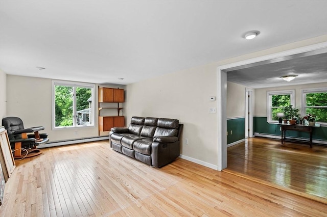 5 Emery Ct, Stoneham, MA 02180 - living room with a baseboard radiator, light wood-type flooring, a baseboard heating unit, and baseboards