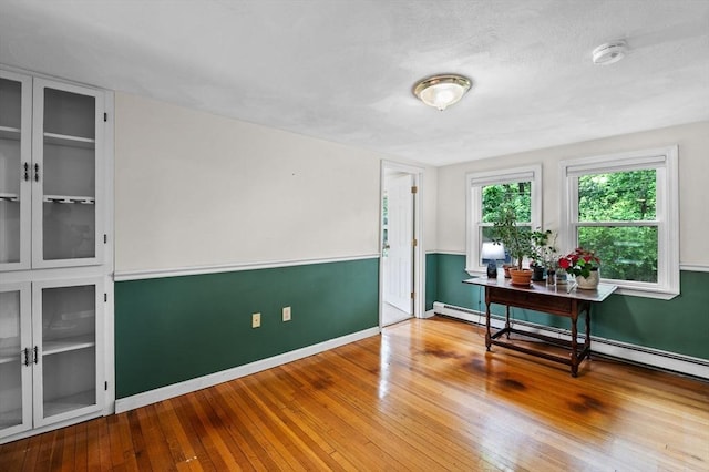 5 Emery Ct, Stoneham, MA 02180 - office area featuring hardwood / wood-style floors, baseboard heating, and baseboards
