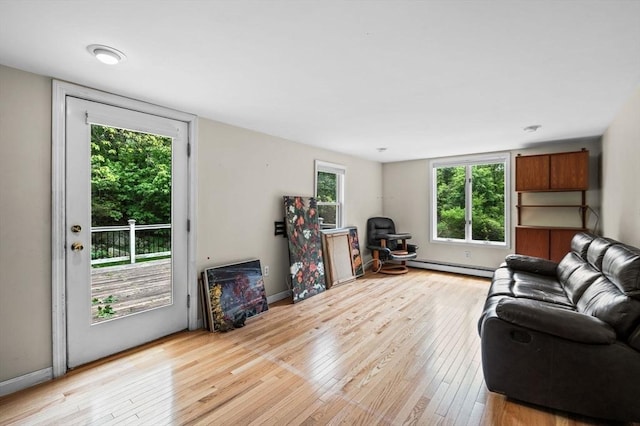 5 Emery Ct, Stoneham, MA 02180 - living area featuring a baseboard heating unit and light wood-style flooring