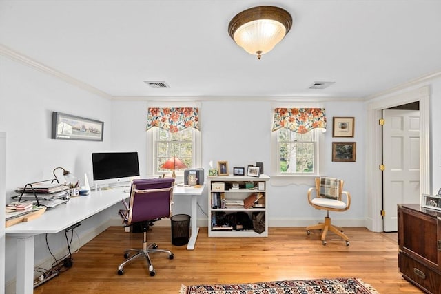 office featuring ornamental molding, wood finished floors, visible vents, and a healthy amount of sunlight