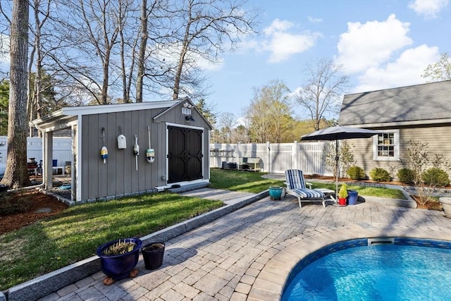 view of swimming pool with a fenced in pool, a fenced backyard, a patio area, an outdoor structure, and a yard