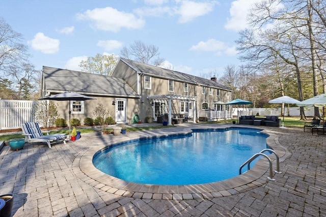 view of swimming pool featuring a fenced in pool, a pergola, fence, a patio, and an outdoor living space