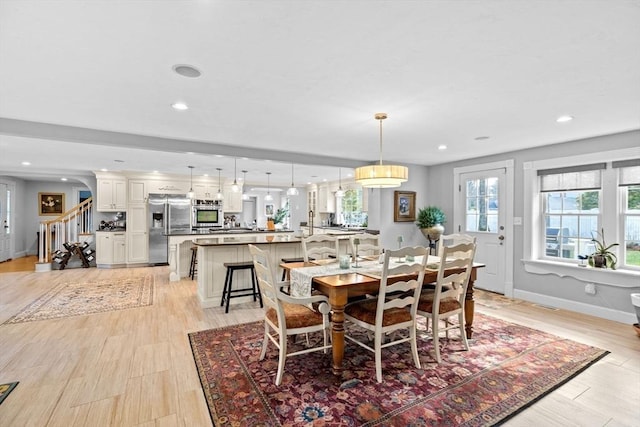 dining room featuring recessed lighting, stairs, and baseboards