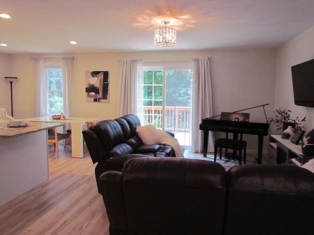 living room featuring a chandelier and light wood-type flooring