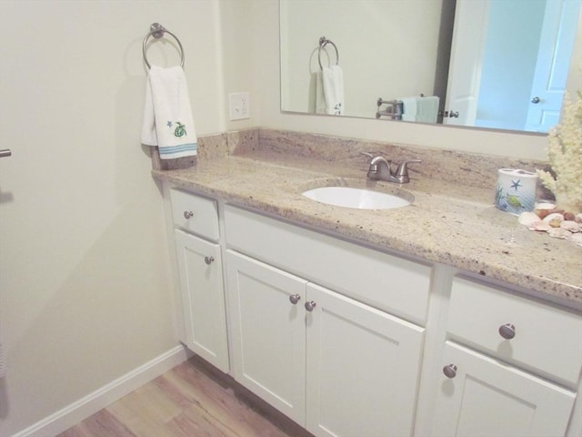 bathroom with vanity and hardwood / wood-style floors