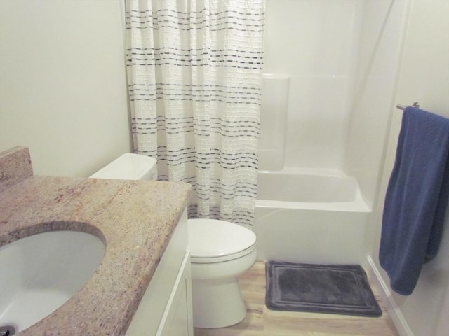 full bathroom featuring hardwood / wood-style flooring, vanity, toilet, and shower / bath combo