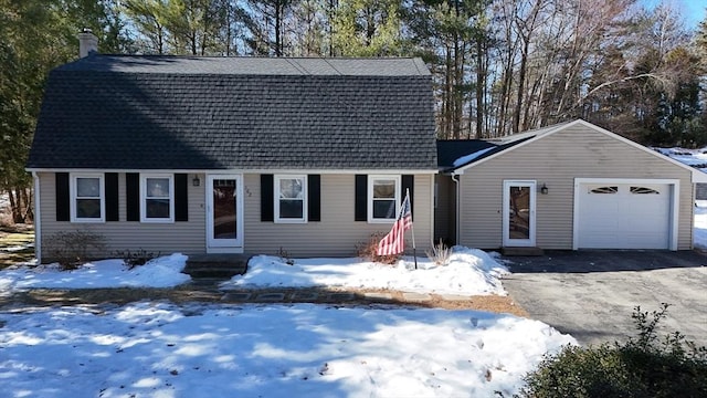 dutch colonial featuring an attached garage, driveway, roof with shingles, and a gambrel roof