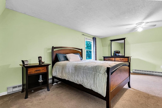 bedroom with ceiling fan, carpet, baseboard heating, and a textured ceiling