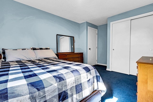 carpeted bedroom featuring a closet, a textured ceiling, and baseboards